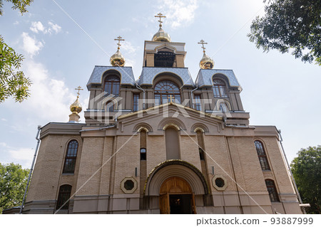 The Orthodox church of healer Panteleimon . A brick-built temple with several domes decorated with crosses The Orthodox church of healer Panteleimon . A brick-built temple with several domes decorated with crosses 93887999