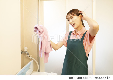 A woman who is worried about shrinking a washed sweater 93888512