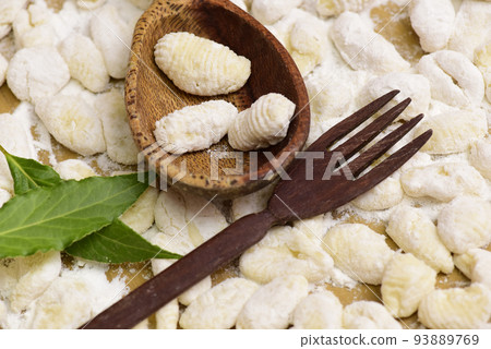 Homemade gnocchi, prepared on the table with ingredients. 93889769