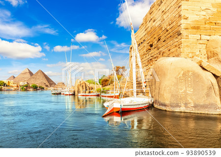 Sailboats near the ancient rocks on the bank of the Nile, Aswan, Egypt 93890539