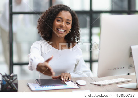 businesswoman offering handshake, standing with extended hand in 93890738