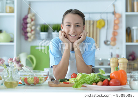 Portrait of cute boy preparing cooking at home 93890883