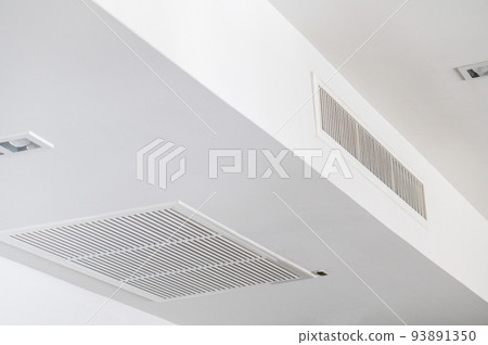 Ceiling mounted cassette type air conditioner and modern lamp light on white ceiling. duct air conditioner for home or office 93891350