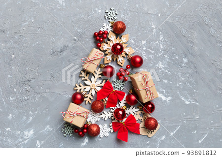 Christmas tree made from colored ball decoration on colored background, view from above. New Year minimal concept with copy space Christmas tree made from colored ball decoration on colored background, view from above. New Year minimal concept with copy space 93891812