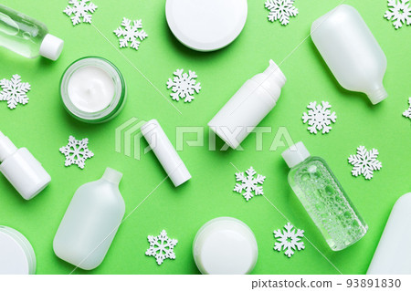 Makeup products and Christmas decorations on color background. Top view New year Beauty concept Makeup products and Christmas decorations on color background. Top view New year Beauty concept 93891830