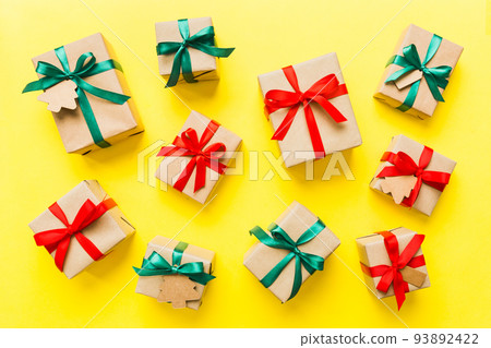 Colored craft gift boxes with colorful ribbons on colored background. Collection of Christmas present boxes 93892422