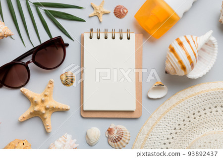 Blank writing book with summer beach accessories on background, copy space. Flat lay with copy space 93892437