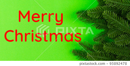 Merry Christmas text. Top view Banner of frame made of fir tree on colorful background with copy space. Merry Christmas concept Merry Christmas text. Top view Banner of frame made of fir tree on colorful background with copy space. Merry Christmas concept 93892478