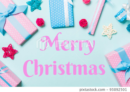 Merry Christmas text. Top view of Christmas decorations on blue background. New Year holiday concept with copy space Merry Christmas text. Top view of Christmas decorations on blue background. New Year holiday concept with copy space 93892501