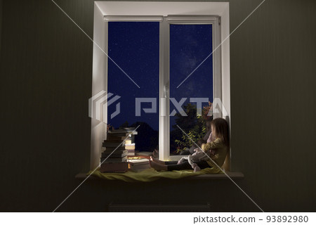 A cute little girl is sitting on the windowsill at night. A cute little girl is sitting on the windowsill at night. 93892980
