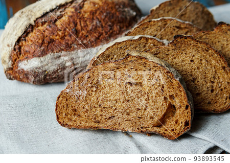 Freshly baked bread with a golden crust close up. 93893545