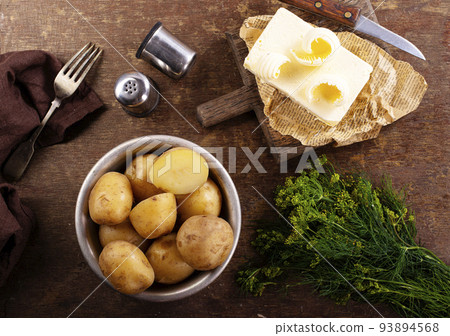 Tasty boiled potatoes with dill and butter in bowl. Top view, flat lay 93894568