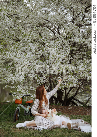 Mom and daughter walk on bicycles 93894704