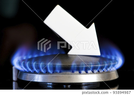 Gas supplies. Reduced gas supplies. Gas stove with a burning flame and an arrow pointing down. The concept of the crisis in winter and the lack of natural gas. Heating season. 93894987