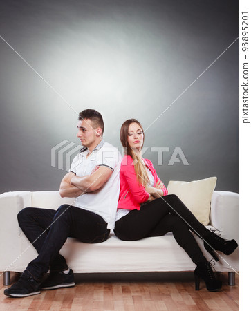 Young couple after quarrel sitting on sofa back to back Young couple after quarrel sitting on sofa back to back 93895201