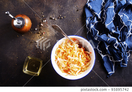 Sauerkraut in a white plate. Homemade sauerkraut with carrot . Fermented food. Natural probiotic. Copy space for text Sauerkraut in a white plate. Homemade sauerkraut with carrot . Fermented food. Natural probiotic. Copy space for text 93895742