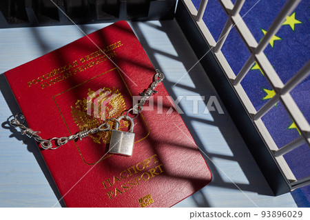 Russian passport chained in a chain with a padlock is located. Prohibition of Schengen visas for Russian tourists. 93896029