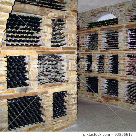 Gerakini, Greece- may 29, 2007: Wine cellars with old aged wine, bottles of wine from different years covered with dust and cobwebs Gerakini, Greece- may 29, 2007: Wine cellars with old aged wine, bottles of wine from different years covered with dust and cobwebs 93896612