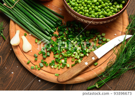 green onion, sweet peas on a dark wooden background, still life, concept of fresh and healthy food green onion, sweet peas on a dark wooden background, still life, concept of fresh and healthy food 93896673