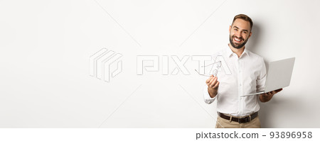 Satisfied businessman praising good job while checking laptop, standing over white background 93896958