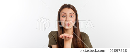Portrait of a young woman blowing a kiss isolated over white. 93897218