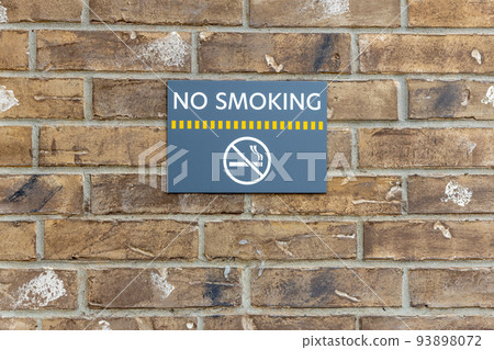 No smoking sign on the building, warning sign on the brick wall background, information about ban of smoking No smoking sign on the building, warning sign on the brick wall background, information about ban of smoking 93898072