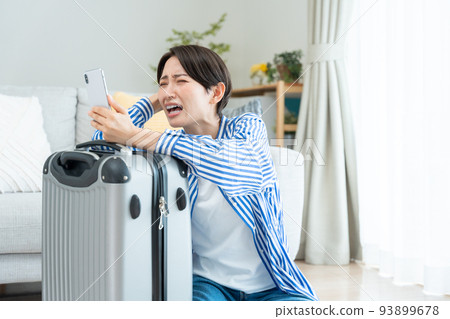 準備旅行的中間女人（智能手機、預訂、取消、問題） 93899678