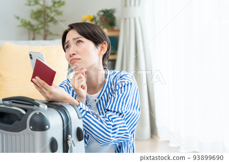 Middle woman preparing to travel (smartphone, passport) Middle woman preparing to travel (smartphone, passport) 93899690