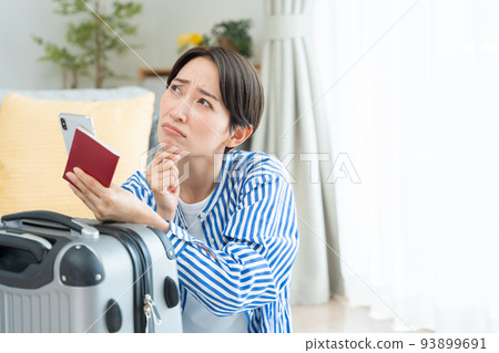 Middle woman preparing to travel (smartphone, passport) Middle woman preparing to travel (smartphone, passport) 93899691