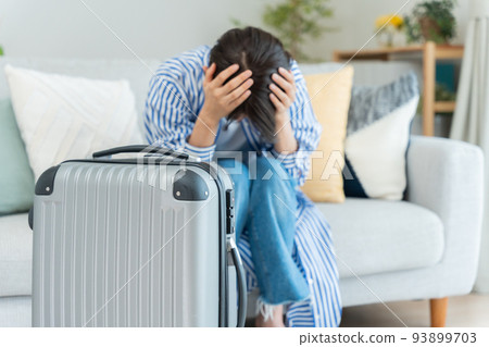 Middle woman preparing for a trip (depressed, shocked, canceled) 93899703