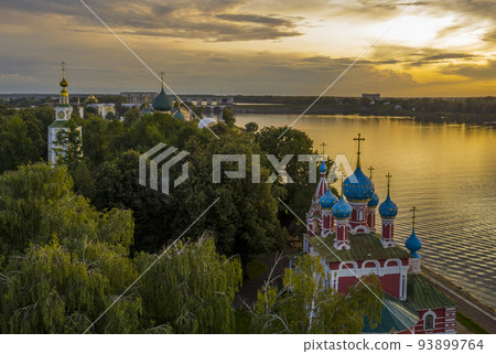 Uglich, Russia. Embankment of the Volga river in Uglich, the temple of Dmitry on Blood in the evening twilight, at sunset 93899764