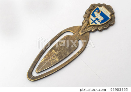 Antique paper clip. It is also used as a bookmark to a book. Old souvenir from Finland. Antique paper clip. It is also used as a bookmark to a book. Old souvenir from Finland. 93903565