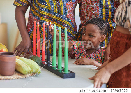 Little child burning candles for holiday Little child burning candles for holiday 93905972
