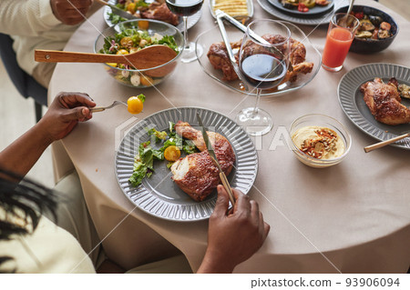 Family eating chicken with salad Family eating chicken with salad 93906094