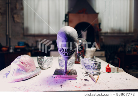 Artisan craftsman create mask based on plaster cast. Gypsum mold and plastic mask sculpting. Artisan craftsman create mask based on plaster cast. Gypsum mold and plastic mask sculpting. 93907778