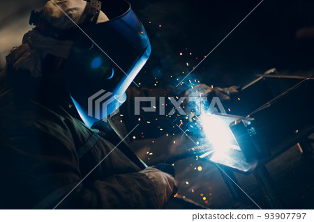Welder welding metal steel industrial part construction on factory. Welder welding metal steel industrial part construction on factory. 93907797
