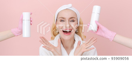 Happy woman chooses face cream hands with u gloved offer choice. Beauty model Happy woman chooses face cream hands with u gloved offer choice. Beauty model 93909056