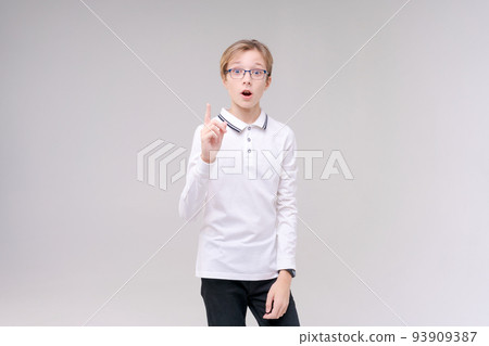 Portrait handsome caucasian boy in glasses who just has an idea points his Portrait handsome caucasian boy in glasses who just has an idea points his 93909387