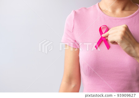 Pink October Breast Cancer Awareness month, woman hand hold pink Ribbon and wear shirt for support people life and illness. National cancer survivors month, Mother and World cancer day concept Pink October Breast Cancer Awareness month, woman hand hold pink Ribbon and wear shirt for support people life and illness. National cancer survivors month, Mother and World cancer day concept 93909627