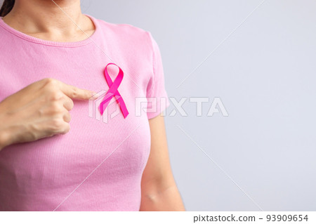 Pink October Breast Cancer Awareness month, woman hand hold pink Ribbon and wear shirt for support people life and illness. National cancer survivors month, Mother and World cancer day concept 93909654