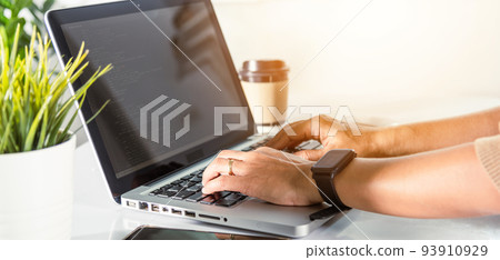 programmer woman writing program code sitting at workplace in office 93910929
