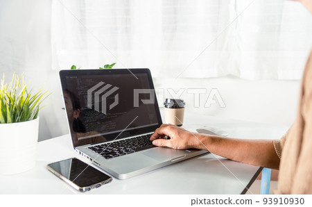Programmer woman writing program HTML code sitting at workplace in office 93910930