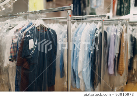 Dry cleaning clothes. Clean cloth chemical process. Laundry industrial dry-cleaning hanging clothes on rack 93910978