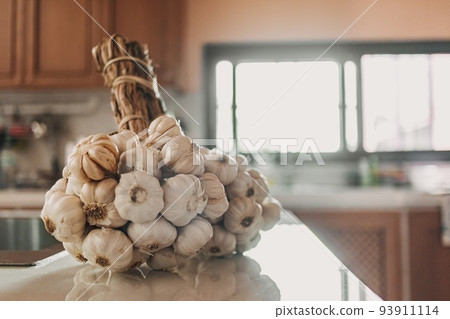 Bunch of garlic on the kitchen table. Concept of preparing to cook. 93911114