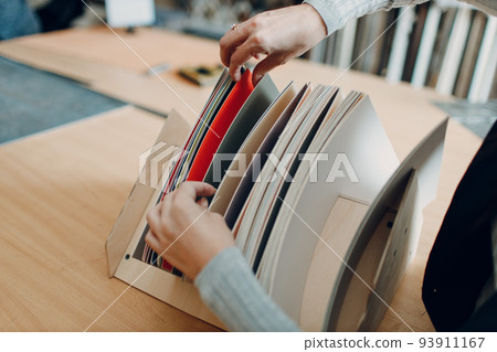 Framing Workshop. Choosing carton cardboard for baguette handmade picture frame at studio. 93911167