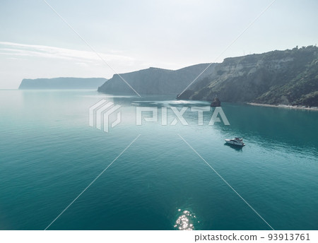 Aerial yacht on calm sea. Luxury cruise trip. View from above of white boat on deep blue water. Aerial view of rich yacht sailing sea. Summer journey on luxury ship. Aerial yacht on calm sea. Luxury cruise trip. View from above of white boat on deep blue water. Aerial view of rich yacht sailing sea. Summer journey on luxury ship. 93913761