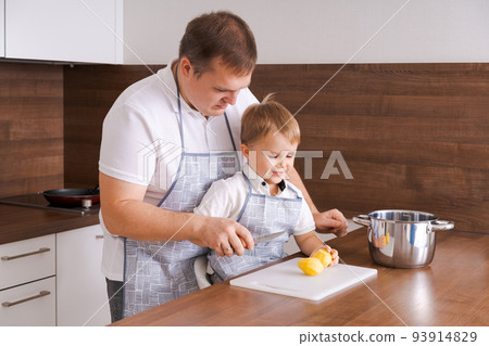 Concept food and nutrition. Shot of two cheerful dad and son posing in kitchen 93914829