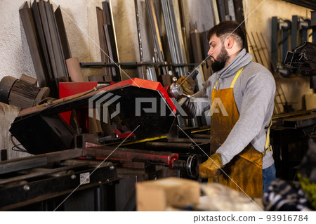 Professional man worker during work in workshop 93916784