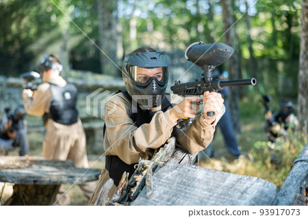 Paintball player recklessly aims with a gun on battlefield 93917073