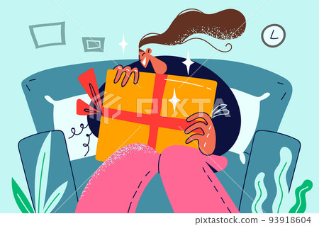Smiling girl sit on sofa with present  Smiling girl sit on sofa with present  93918604
